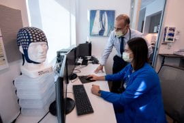 <p>In the sleep clinic’s control room, Dr. Rami Khayat and coordinator Alana Sherrill review physiological measurements from an overnight patient. The cap at left can track more than 200 brain wave signals.</p>
<p>Steve Zylius / UCI</p>
