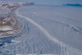 <p>Petermann Glacier drains about 4 percent of the Greenland Ice Sheet as it moves inexorably toward the Arctic Ocean. A new observation and modeling study shows that the glacier is more vulnerable than previously thought to the intrusion of warm ocean water on its underside, leading to accelerated melting and boosting the potential severity of future sea level rise. Eric Rignot / UCI</p>
