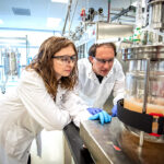 <p>Christina Boville (2019 Cyclotron Road fellow) and David Romney of Aralez Bio at the Advanced Biofuels and Bioproducts Process Development Unit (ABPDU). (Credit: Thor Swift/Berkeley Lab)</p>

